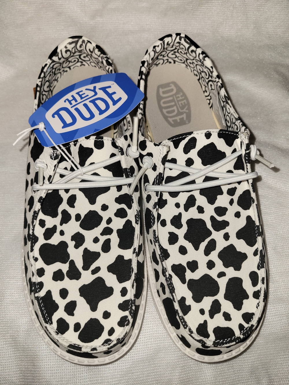 Hey Dude Cow Print Wally Slip-On Shoes in Black & White